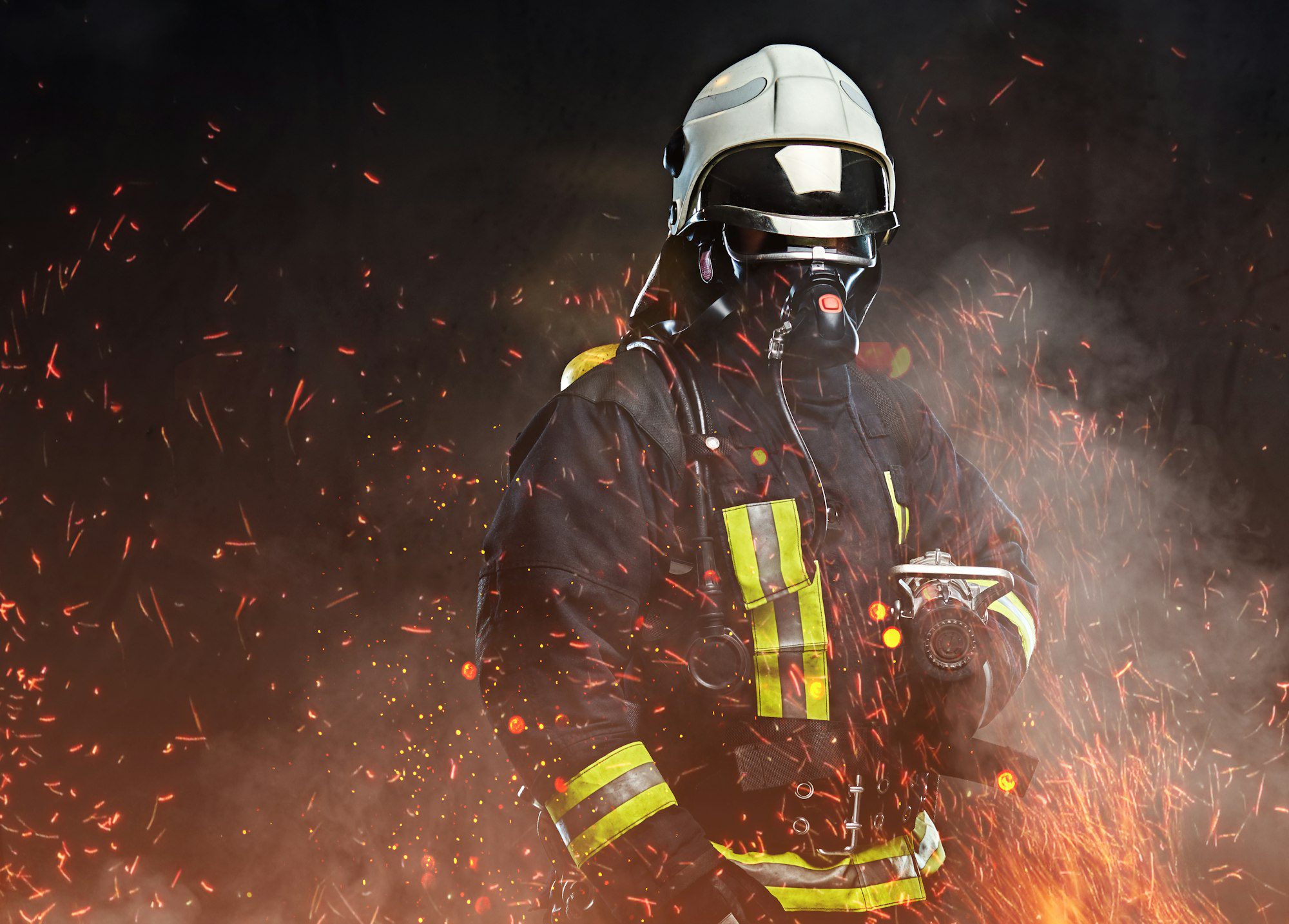 Firefighter in protective gear with helmet and mask, surrounded by sparks and smoke, symbolizing emergency response and firefighting services.